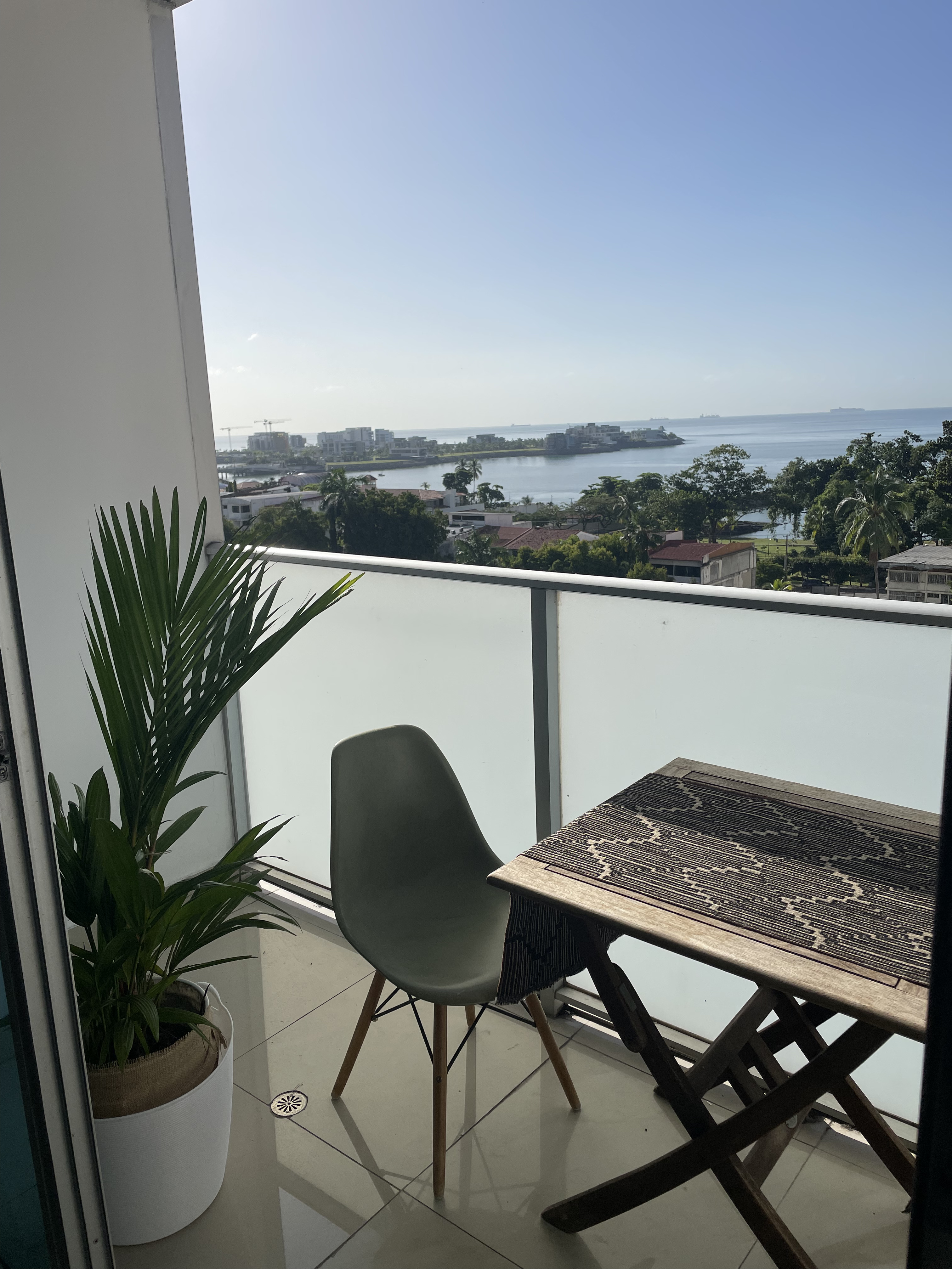 A furnished apartment balcony overlooking Panama's bay in morning light — what a finished, move-in-ready property actually looks like