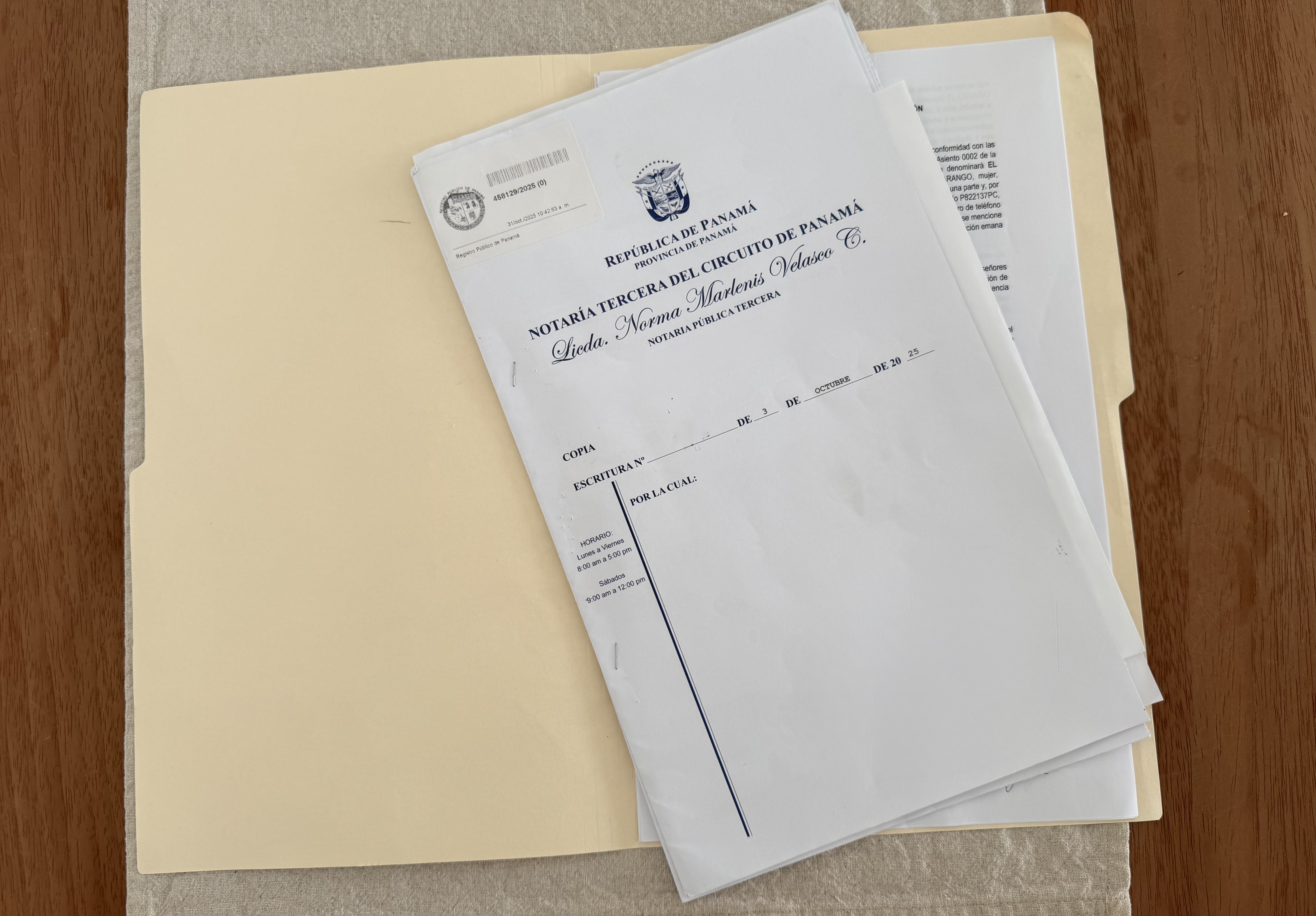 Property documents and a finca registry printout on a desk — the paperwork that proves legal ownership in Panama